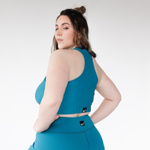 Plus size compression sports bra from recycled polyamide and elastane in turquoise colour from the back