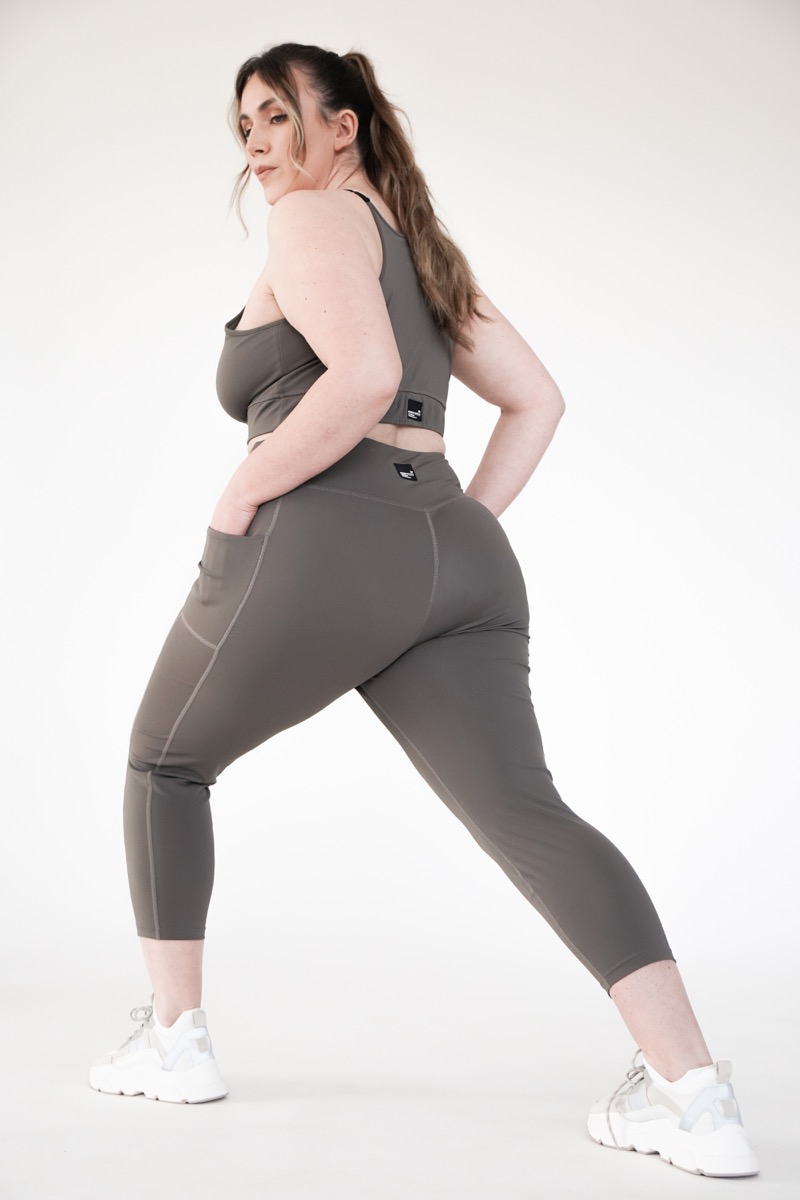 Plus size high impact leggings with a pocket in brown grey colour from the back