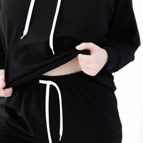 Plus size joggers from cotton blend in black colour close logo view