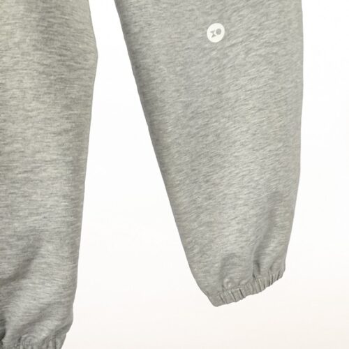 Plus size joggers from cotton blend in grey colour close logo view