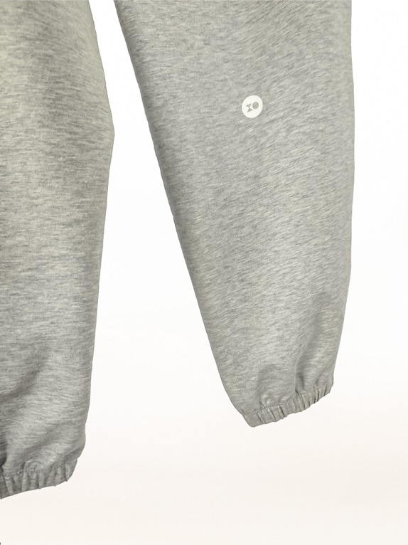 Plus size joggers from cotton blend in grey colour close logo view